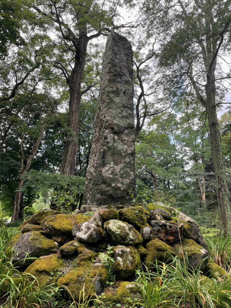 A stone monument marks a traditional burial ground where the Mohican people have long remembered and honored their lost families.