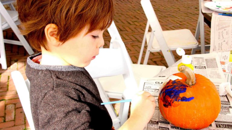 A Berkshire family paints pumpkins at a Halloween event at the Mount.