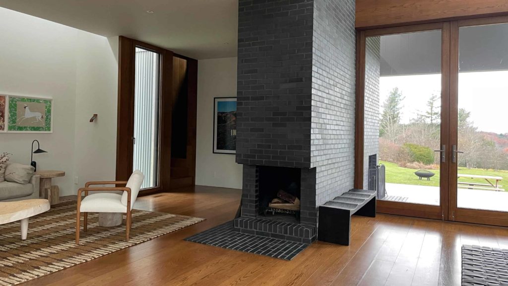 The Tsai Residence holds a fireplace in its broad open living room at the Forge Project.