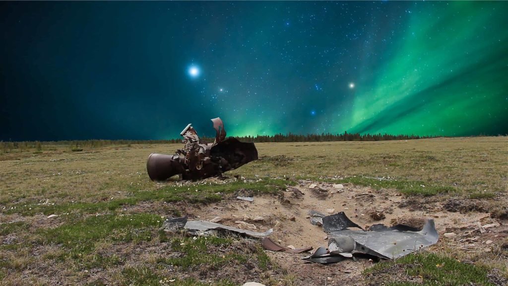 The northern lights dance above the open ridges and the debris of space flight near Churchill in Manitoba, in a film still from Allison Maria Rodriguez' art installation 'all that moves.'
