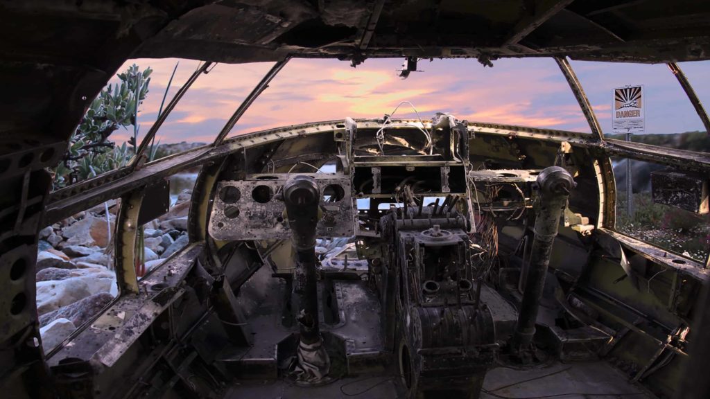 A crashed plane overlooks a lake and valley near Churchill in Manitoba, in a film still from Allison Maria Rodriguez' art installation 'all that moves.'