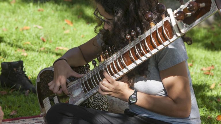 One of Veena Chandra's Sitar students performs outdoors on Mountain Day at Williams College. Press image courtesy of Williams College