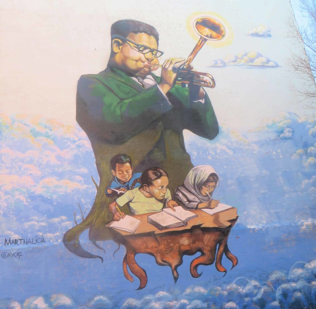 Dizzy Gillespie plays his horn with students, floating in a blue sky, in a mual by Marthalicia Matarrita in Harlem, N.Y. Creative Commons courtesy photo