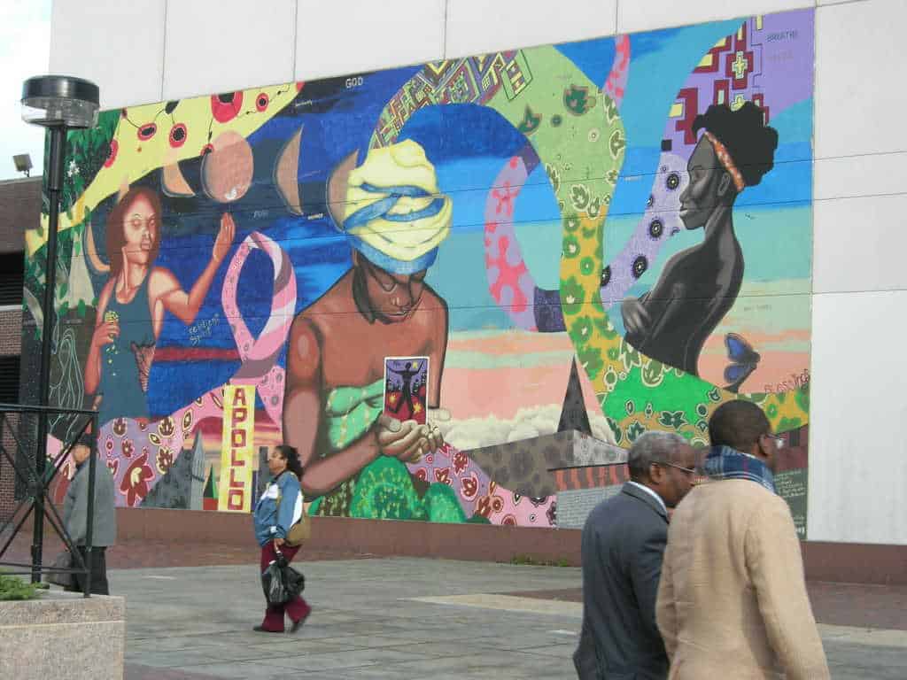 A mural shows people dancing, listening to music, swirled in color in Harlem, N.Y. Creative Commons courtesy photo