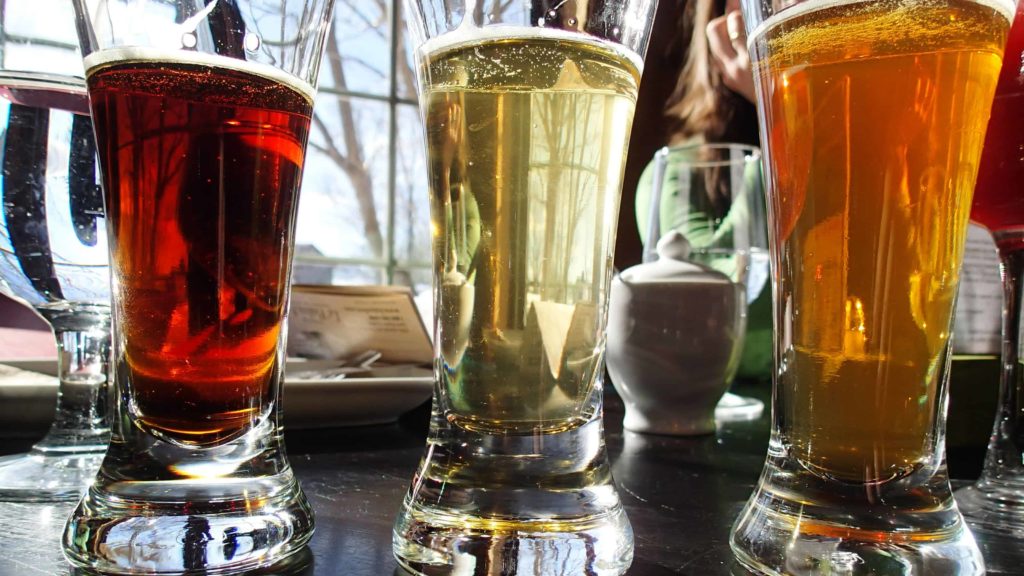Three glasses of beer catch the light in varying shades of tan and gold and brown. Creative Commons courtesy photo.