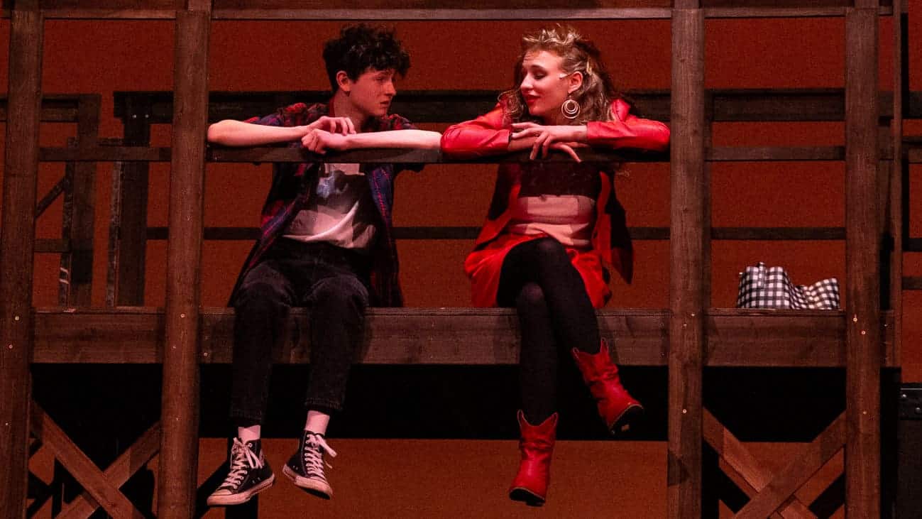 Kate Gobel as Ariel and Alex Boyd as Ren McCormack share confidences on a railway bridge at night in Footloose with the Berkshire Theatre Group. Press photo courtesy of BTG.