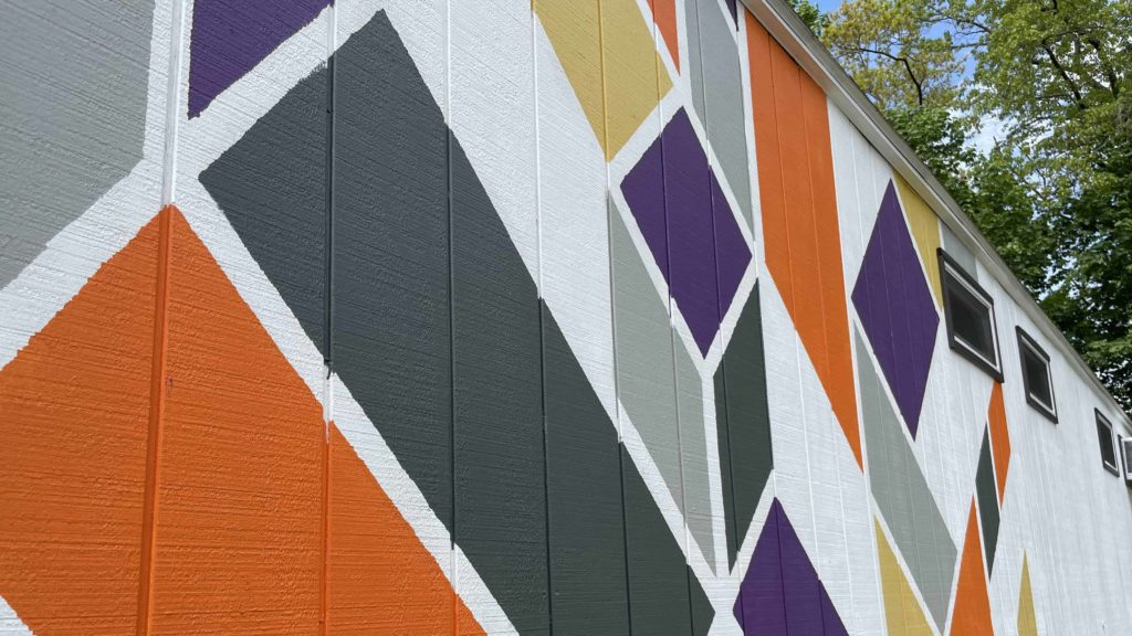 An upcycled vintage mobile home wears a bright mural in Art Park in Chatham, N.Y.