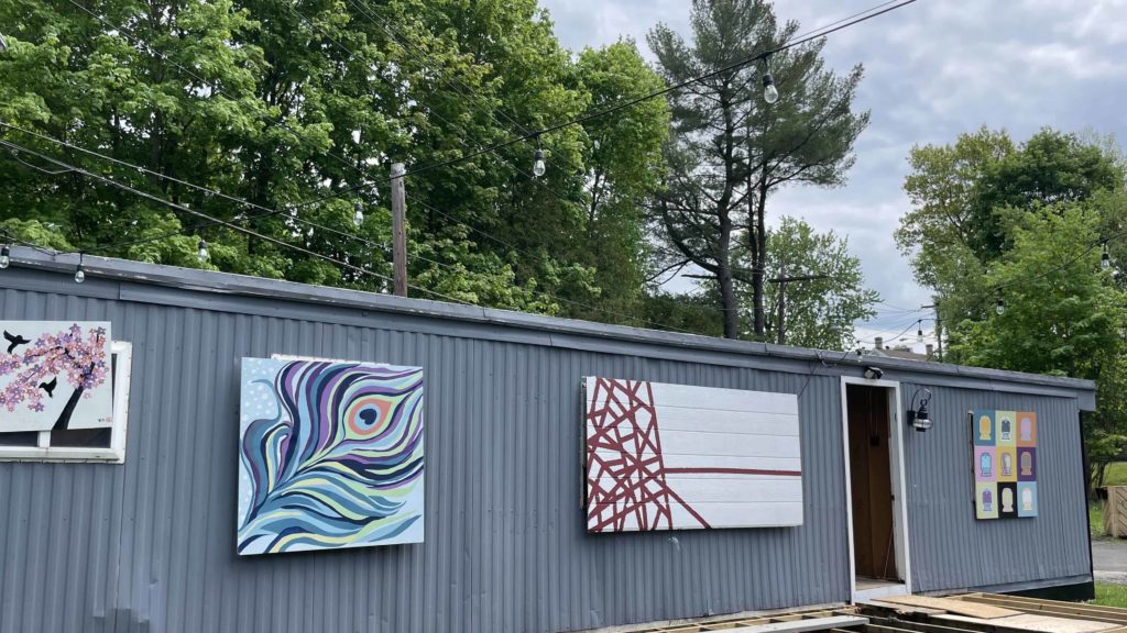 A vintage mobile home wears bright paintings in Art Park in Chatham, N.Y.