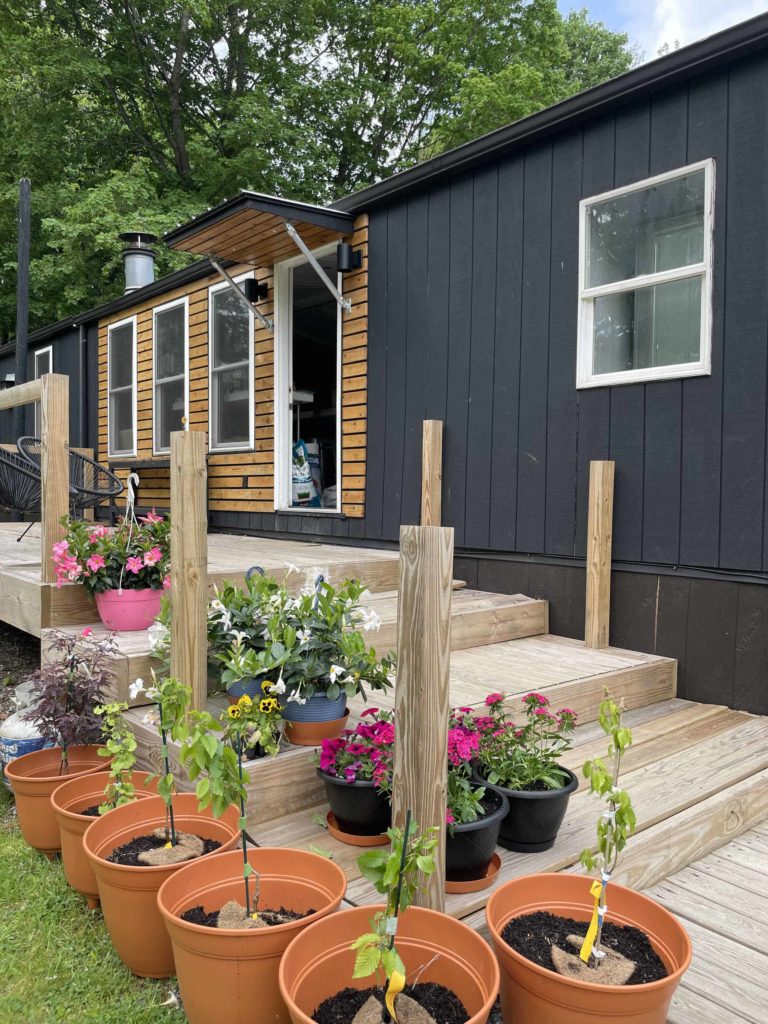 Flower pots brighten the deck of an upcycled vintage mobile home in Chatham, N.Y.