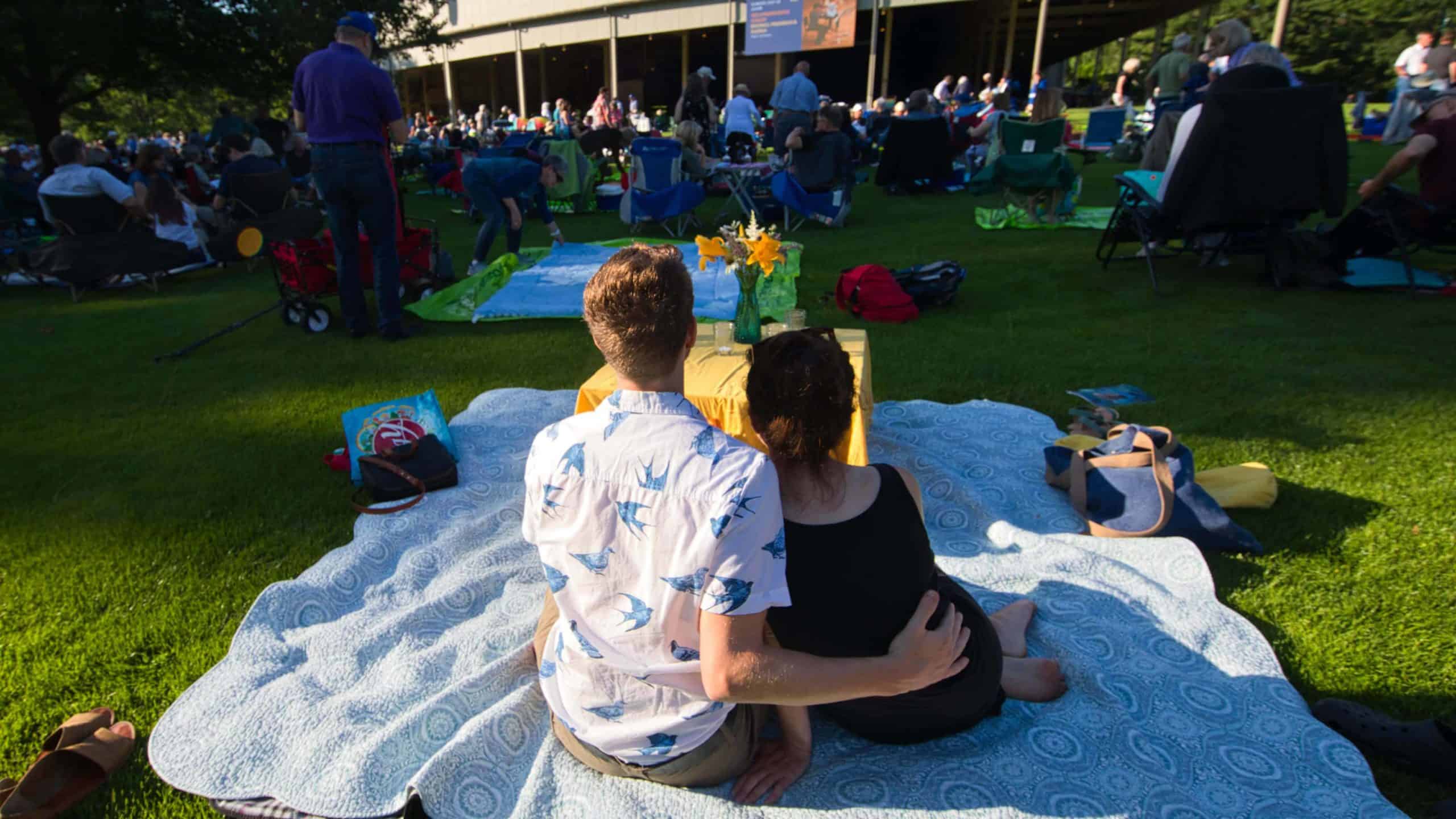 A couple sit on a blanket on the Tanglewood Lawn, listening to Beethoven. Press photo courtesy of the Boston Symphony Orchestra