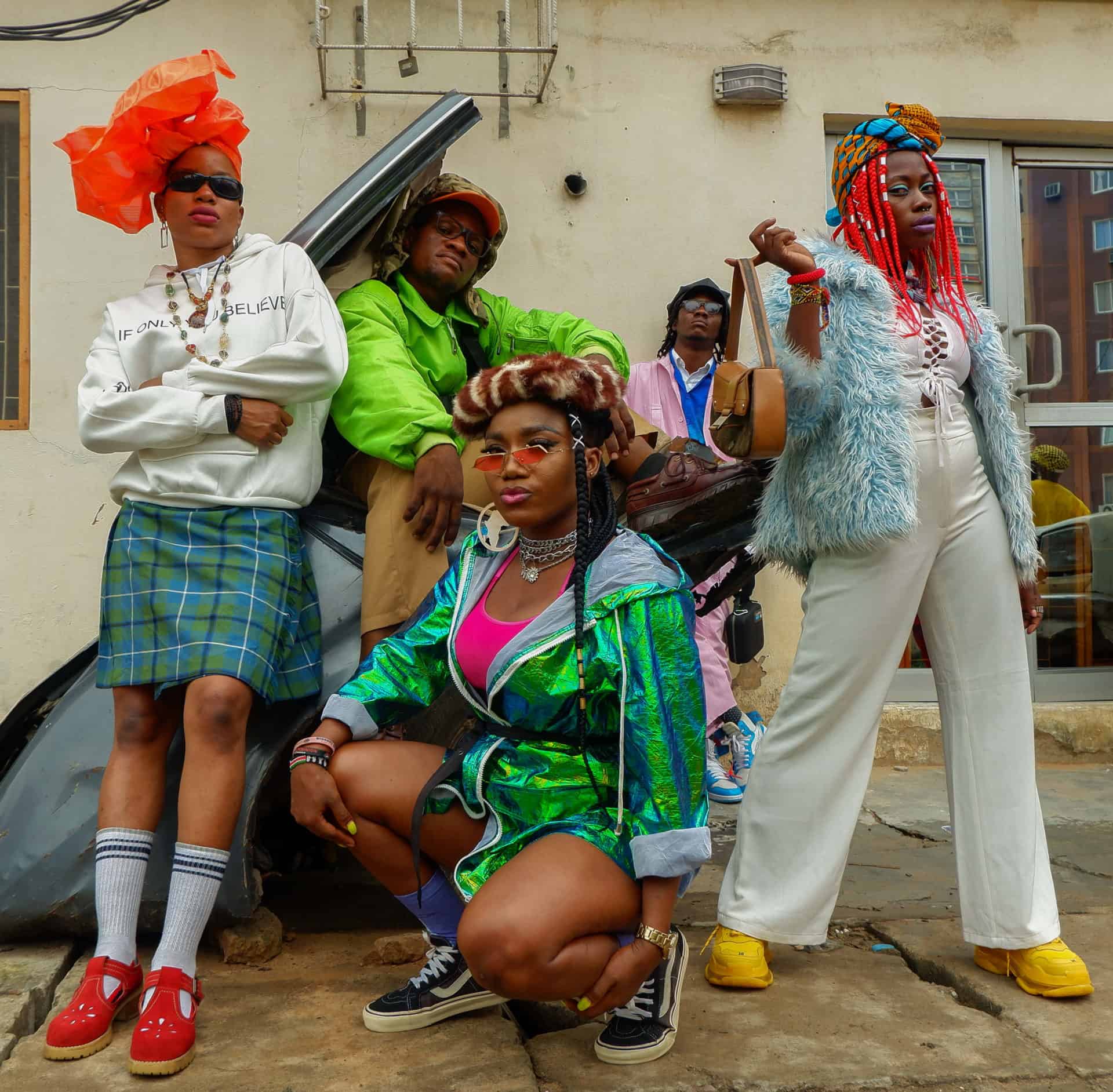 Performers from QDance Company in Lagos, Nigeria, gather on the sidewalk in brilliantly colorful contemporary clothing. Press photo courtesy of PS21 and the artists