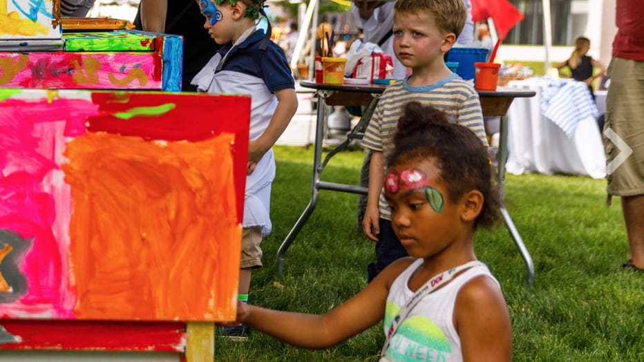 Kids and families paint and create art with paper on the lawn on a sunny day at the Clark Art Institute. Press photo courtesy of the museum