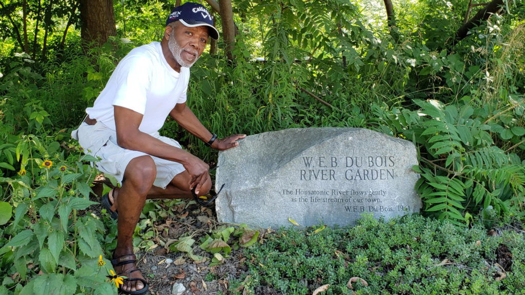 Dennis Powell stands by the stone memorial in the W.E.B. DuBois garden along the River Walk.