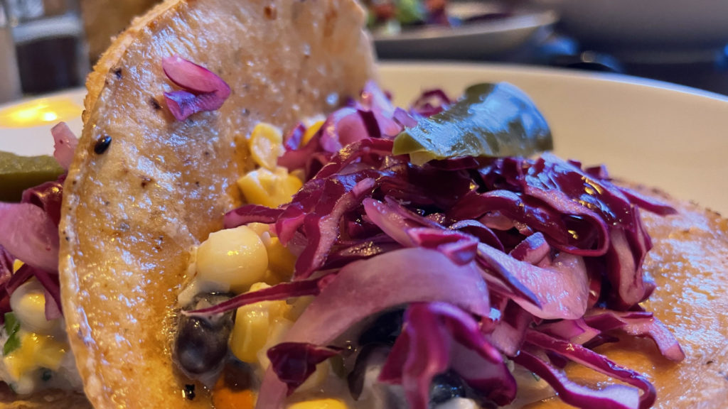 Corn tacos with red cabbage glisten red and gold at Nudel in Lenox.