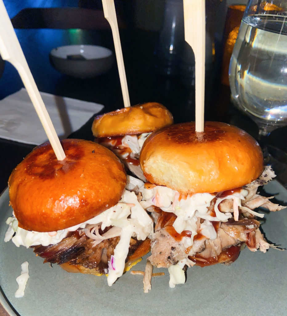 Three generously stuffed sliders catch the light at the Barn restaurant in the Williams Inn.