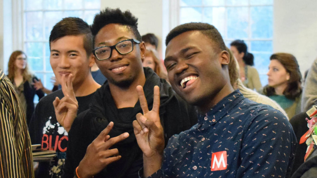 Two visitors to Mass MoCA, young Black men, laugh and hold their hands in Victory signs at Mass MoCA. Press photo courtesy of Mass MoCA