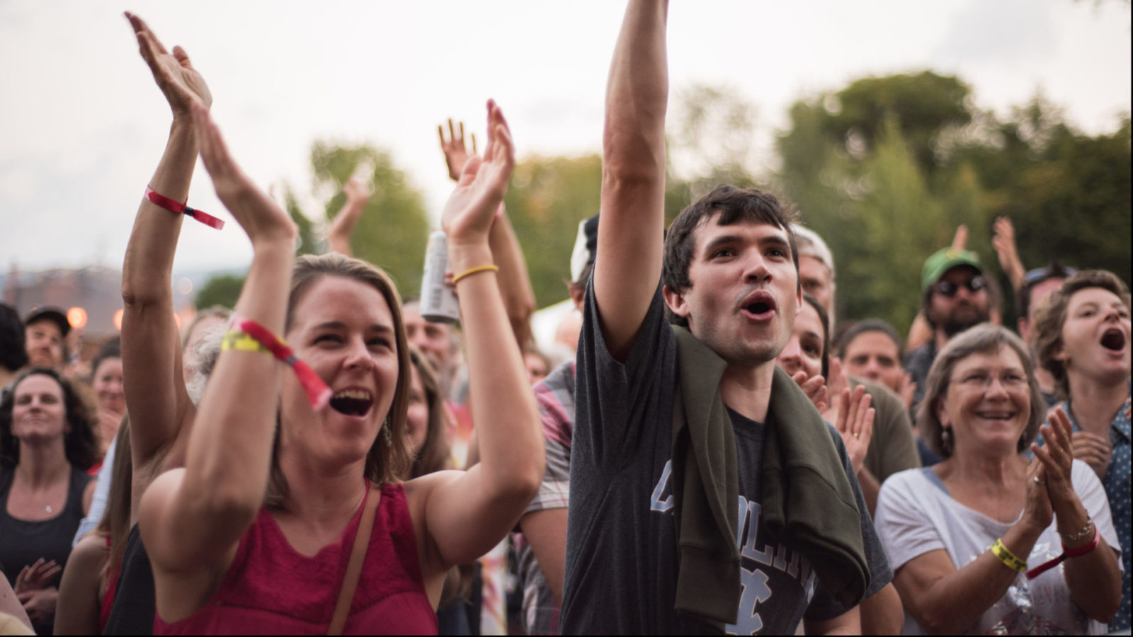 The crowd waves and cheers around the outdoor stage at FreshGrass 2017. Press photo courtesy of Mass MoCA.
