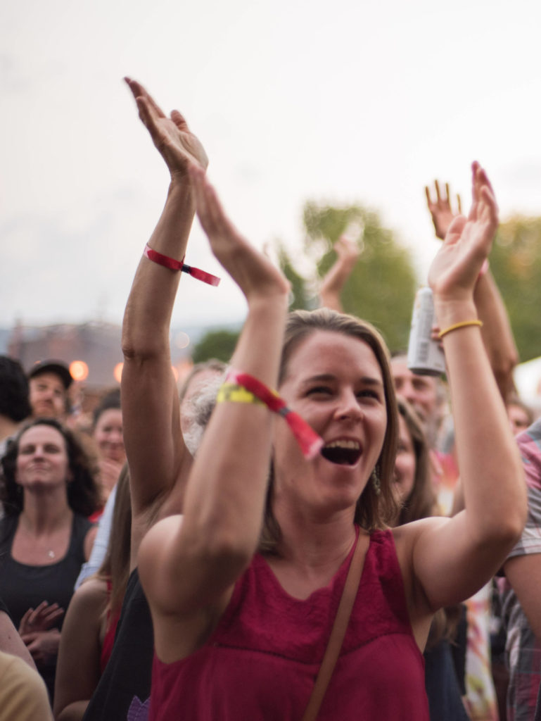 The crowd waves and cheers around the outdoor stage at FreshGrass 2017. Press photo courtesy of Mass MoCA.