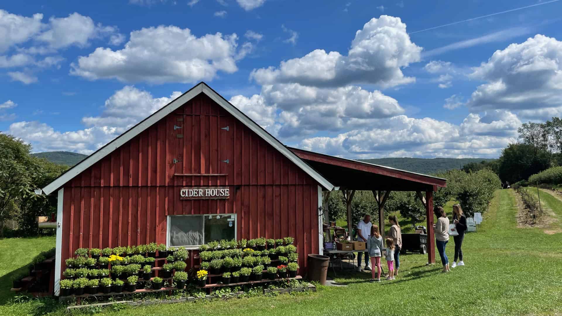 A family waits in the sun by the cider house at Lakeview Orchards in Lanesborough.