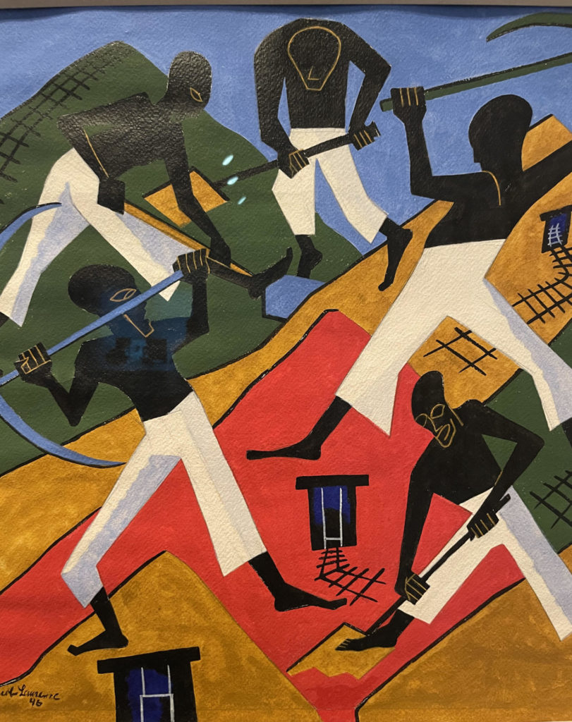 South African gold miners dig, in bold abstracted color in Jacob Lawrence's painting. Press image courtesy of the Norman Rockwell Museum