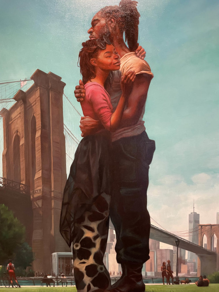 A Black man and women hold each other close near the Brooklyn Bridge in the sunlight in Kadir Nelson's painting The Homecoming. Press image courtesy of the Norman Rockwell Museum