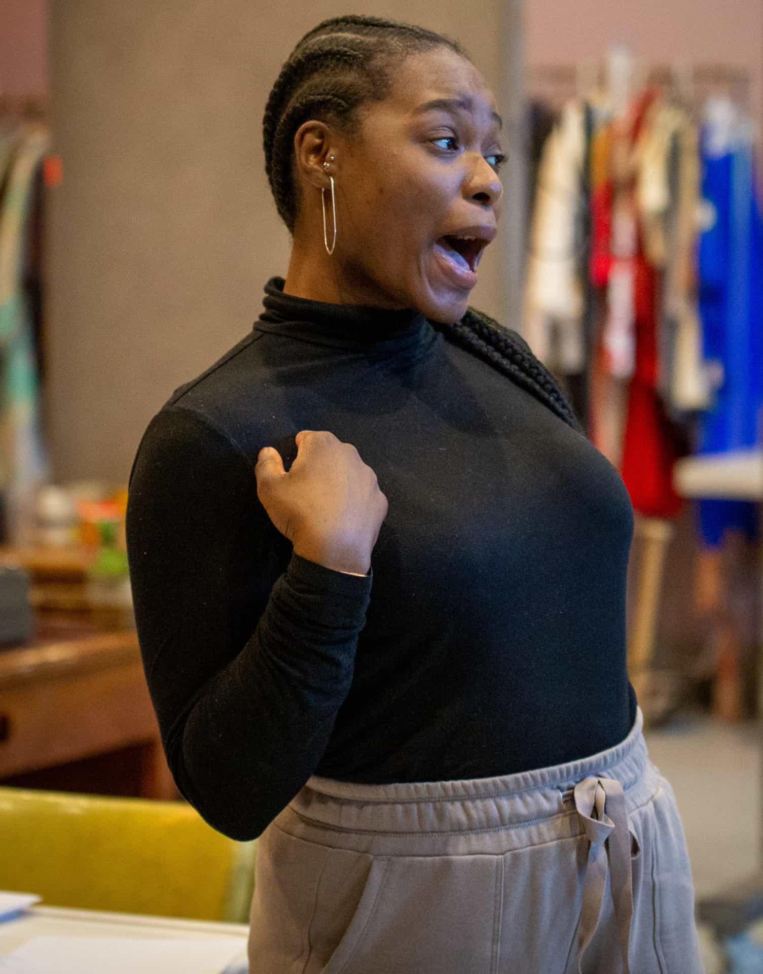Kyra Davis laughs with a gesture of strength in Cadillac Crew with WAM Theatre. Press photo courtesy of the theater