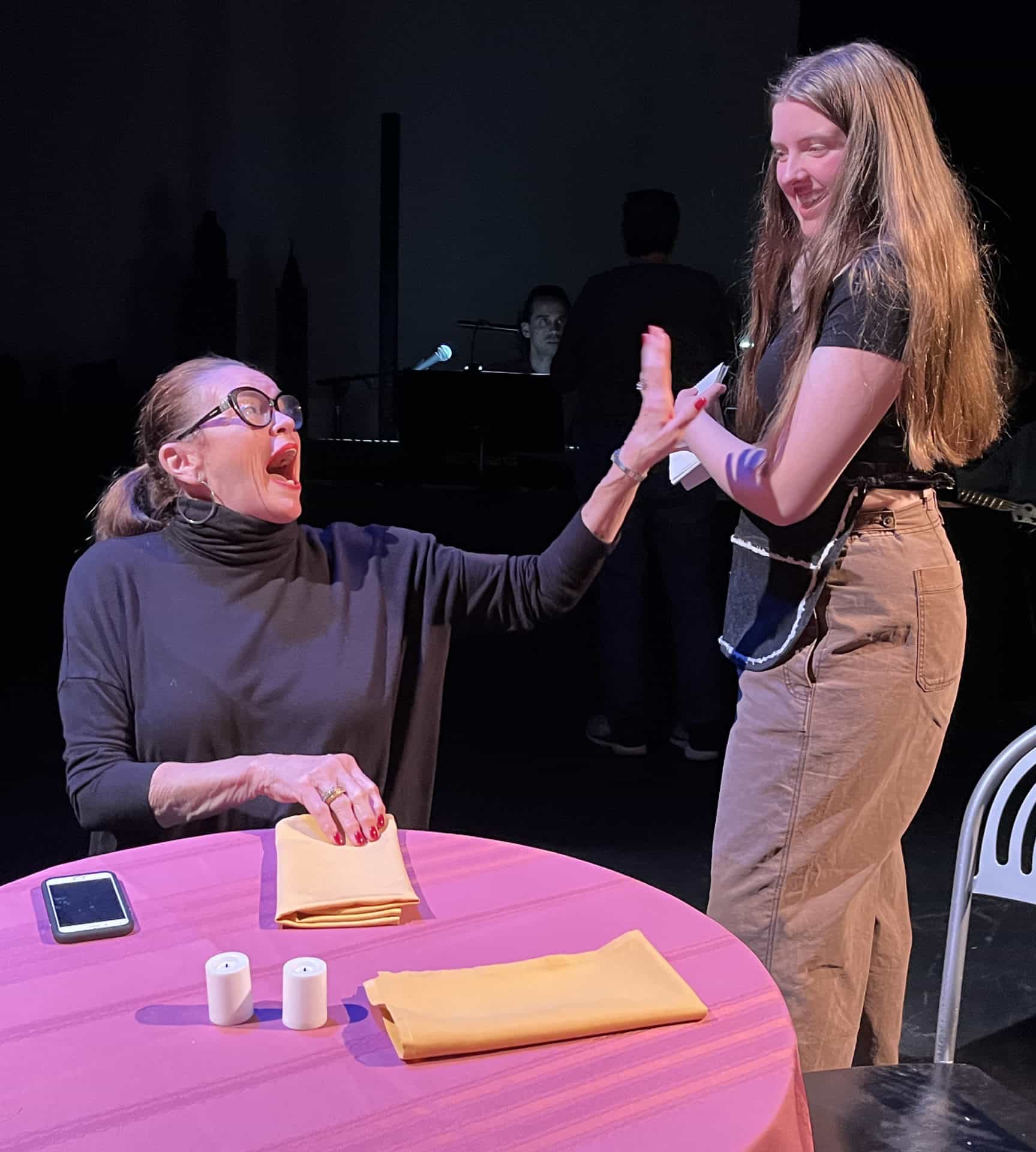 Mary Jo Greco laughs at a cafe table in Slideshow, an evening of short plays at the Bennington Performing Arts Center. Press photos courtesy of the Bennington Community Theater