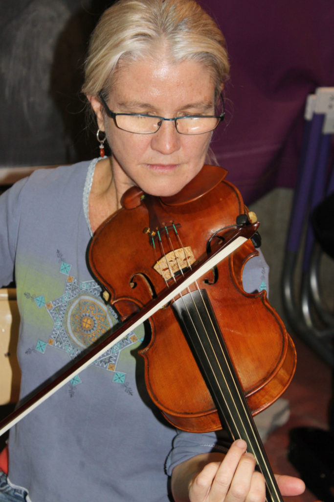 Cassandra Cleghorn plays fiddle with the Mass MoCA Jam musicians at a Berkshire Grown farmers market.
