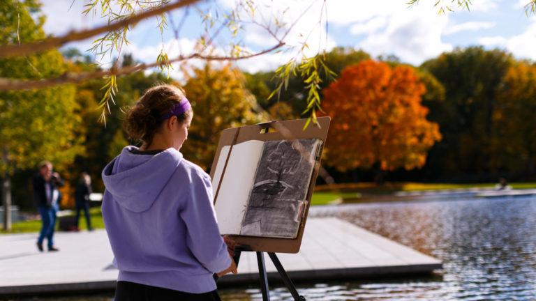 A young visitor draws on the terrace of the Clark Art Institute on a fall day. Press image courtesy of the Clark