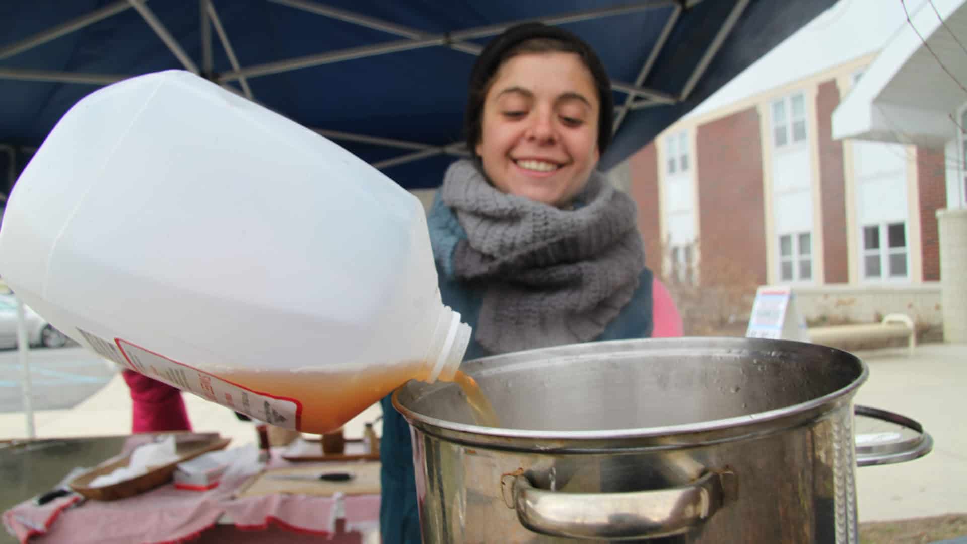 Local makers top up the hot cider mulling outside a Berkshire Grown indoor winter farmers market.