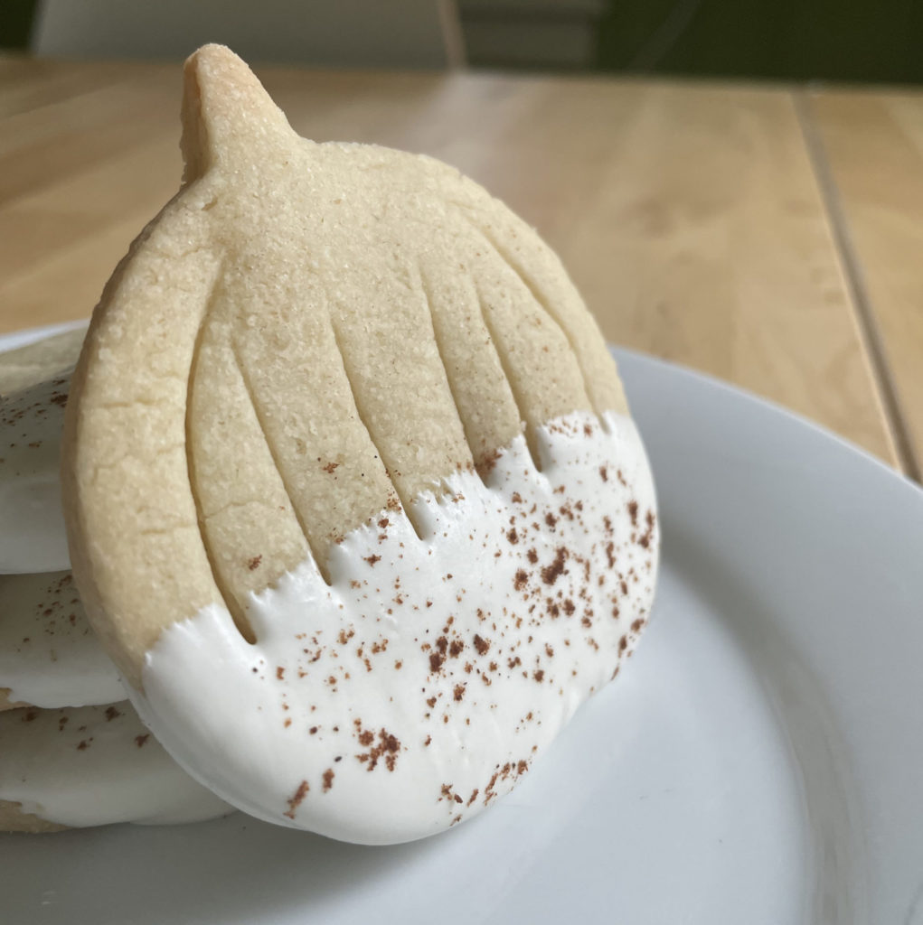 Pumpkin shortbread cookies from Sweet Sam Bakes are dipped in white chocolate. Press photo courtesy of the artist