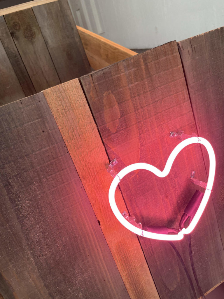 A heart made of found neon glows deep pink in Brake Run Helix in Building 5 at Mass MoCA.