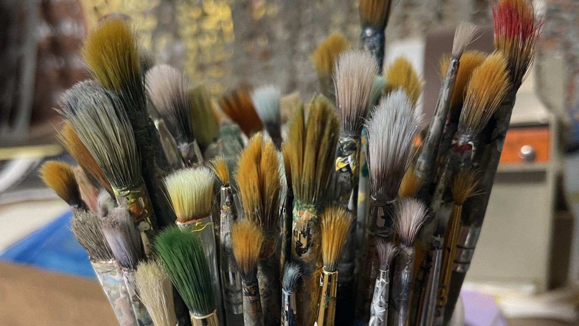 Paintbrushes stand in bright colors in the print shop at the Old Stone Mill in Adams.