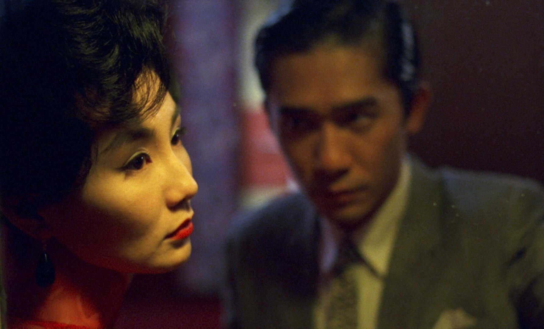 In Hong Kong, 1962: Chow Mo-Wan (Tony Leung Chiu Wai) and Su Li-Zhen (Maggie Cheung Man Yuk) meet on a city street at night in 'In the Mood for Love.' Press film still courtesy of Images Cinema