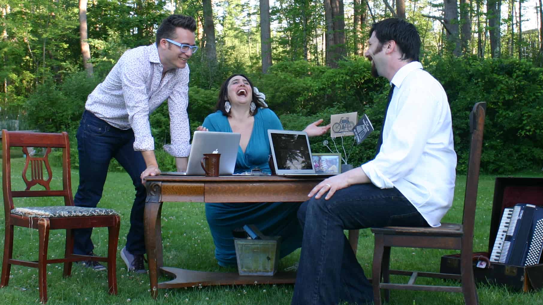 The founders of the Berkshire Fringe Festival including Sara Katzoff laugh together at an outdoor table. Press photo courtesy of Berkshire Fringe