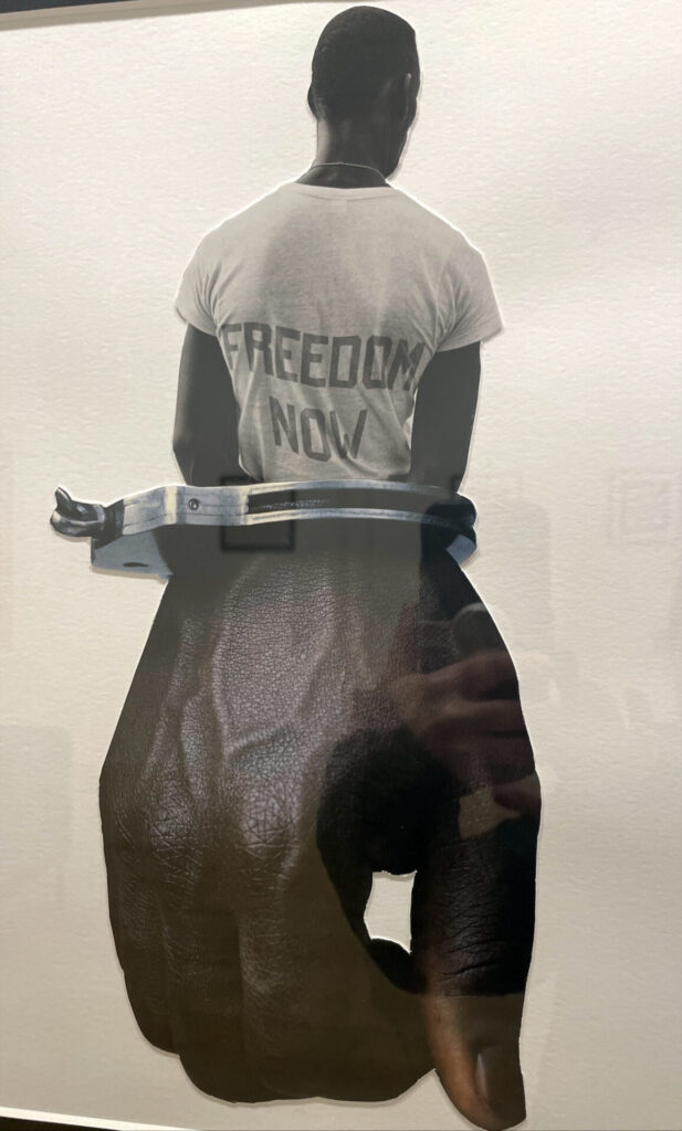 A Man stands facing away, melded with a manacled hand, in Heather Polk's collage 'Freedom now' at MCLA.