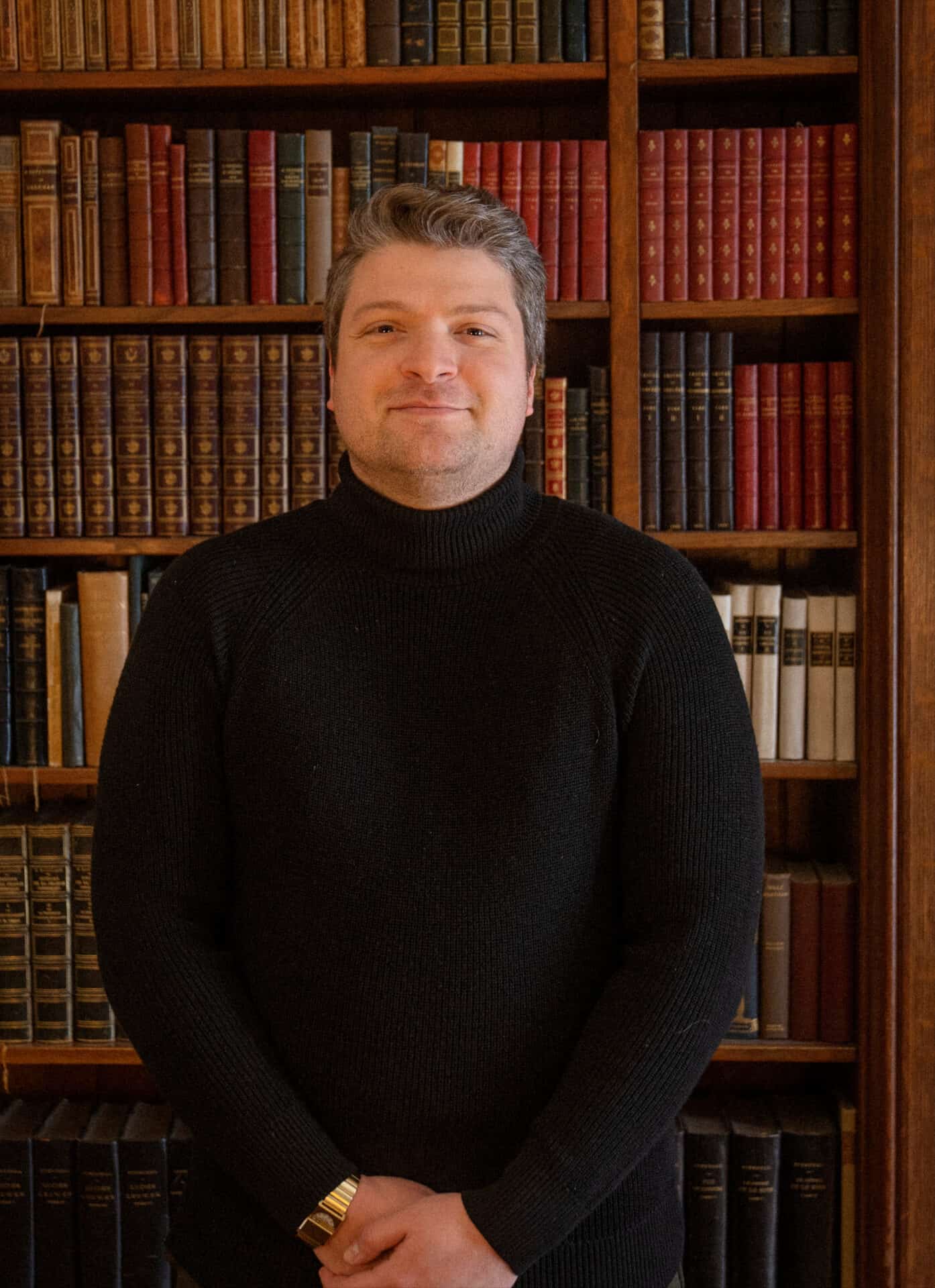 Mario Giannone ooks out from Edith Wharton's library, standing by the shelves, in the week when he and Kat Wei and Parvati Ramchandani come to the Mount as writers in residence. Press photo courtesy of the Mount