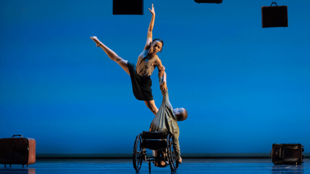 AXIS Dance Company's Alaja Badalich and Janpi Star perform, one dancer in a wheelchair holding another in the air.