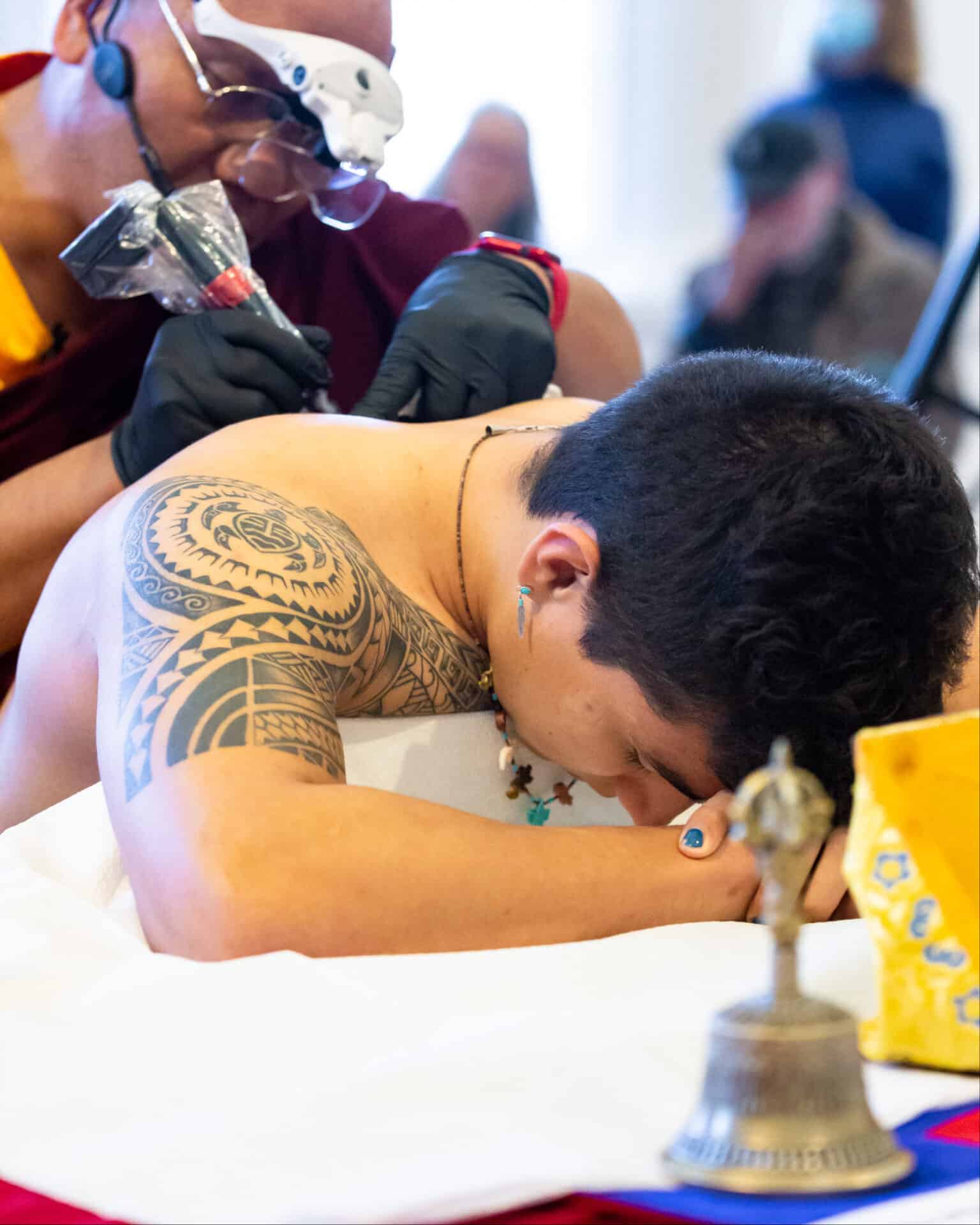 Artist Lama Tashi Norbu applies a tattoo he has designed for Isaac Rivera, Williams college '26. Press photo courtesy of the Williams College Museum of Art