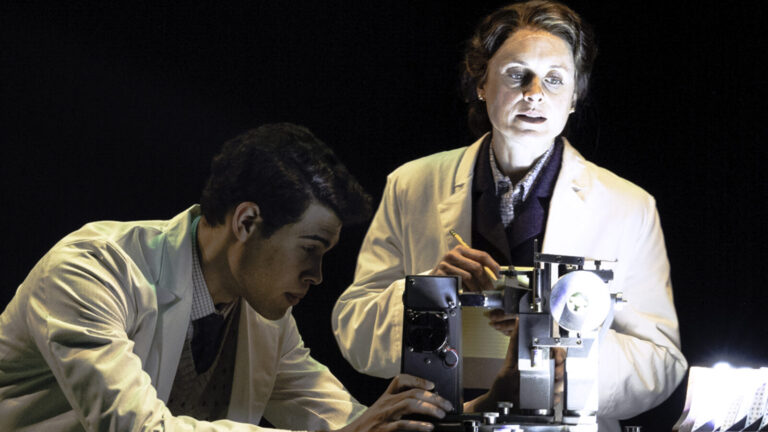 Brandon Dial and Rebecca Brooksher look into a microscope in Photograph 51. Press photo courtesy of Berkshire Theatre Group
