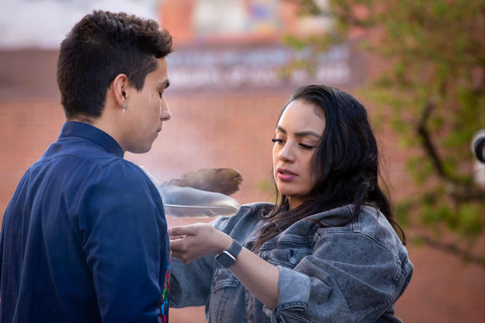 Isaac Rivera '26 and Daisy Rosalez '25 share a moment of ritual and sacred smoke in the courtyard outside WCMA. Press photo courtesy of the Williams College Museum of Art