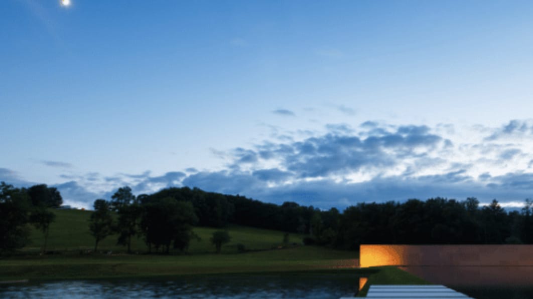 The full moon glimmers over the reflecting pool and Stone Hill at dusk at the Clark Art Institute. Press photo courtesy of the museum