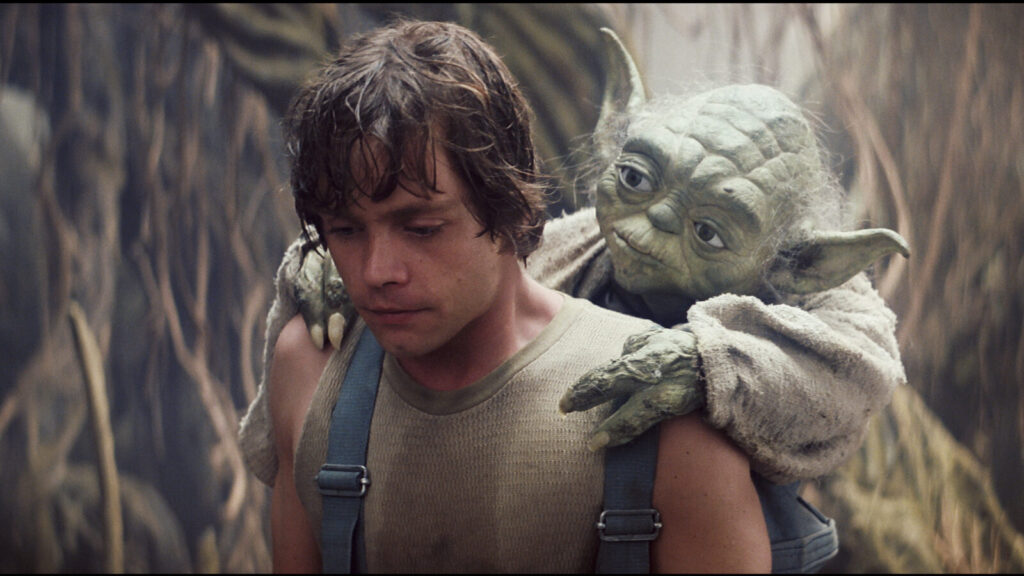 Luke Skywalker (Mark Hamill) carries Jedi master Yoda (Frank Oz) through the swamps of Dagoba. Press photo courtesy of the Mahaiwe