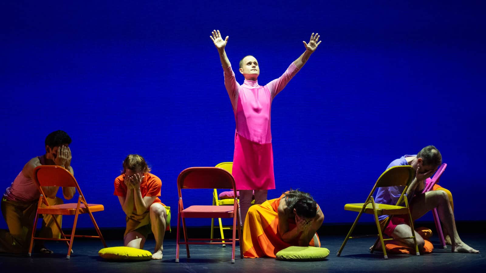 Dallas McMurray stands in a circle of listeners with his arms spread wide in Mark Morris' The Look of Love. Photo courtesy of Jacob's Pillow Dance Festival