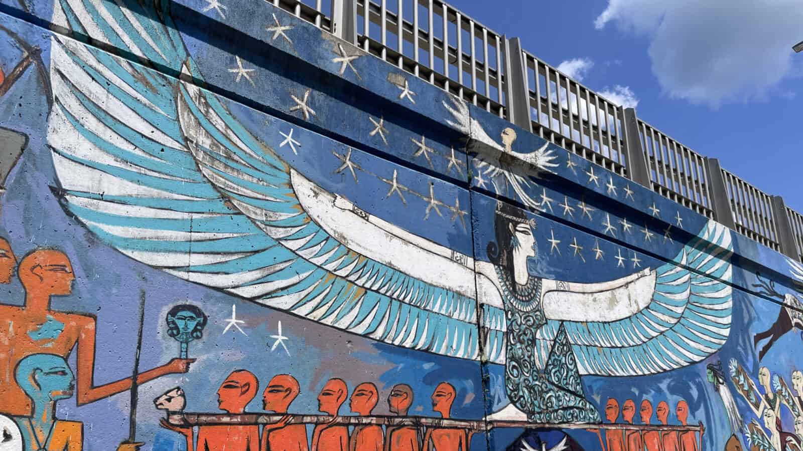 A turquoise and lapis blue woman spreads her wings on the overpass in Egyptian artist Alaa Awad's mural in North Adams.