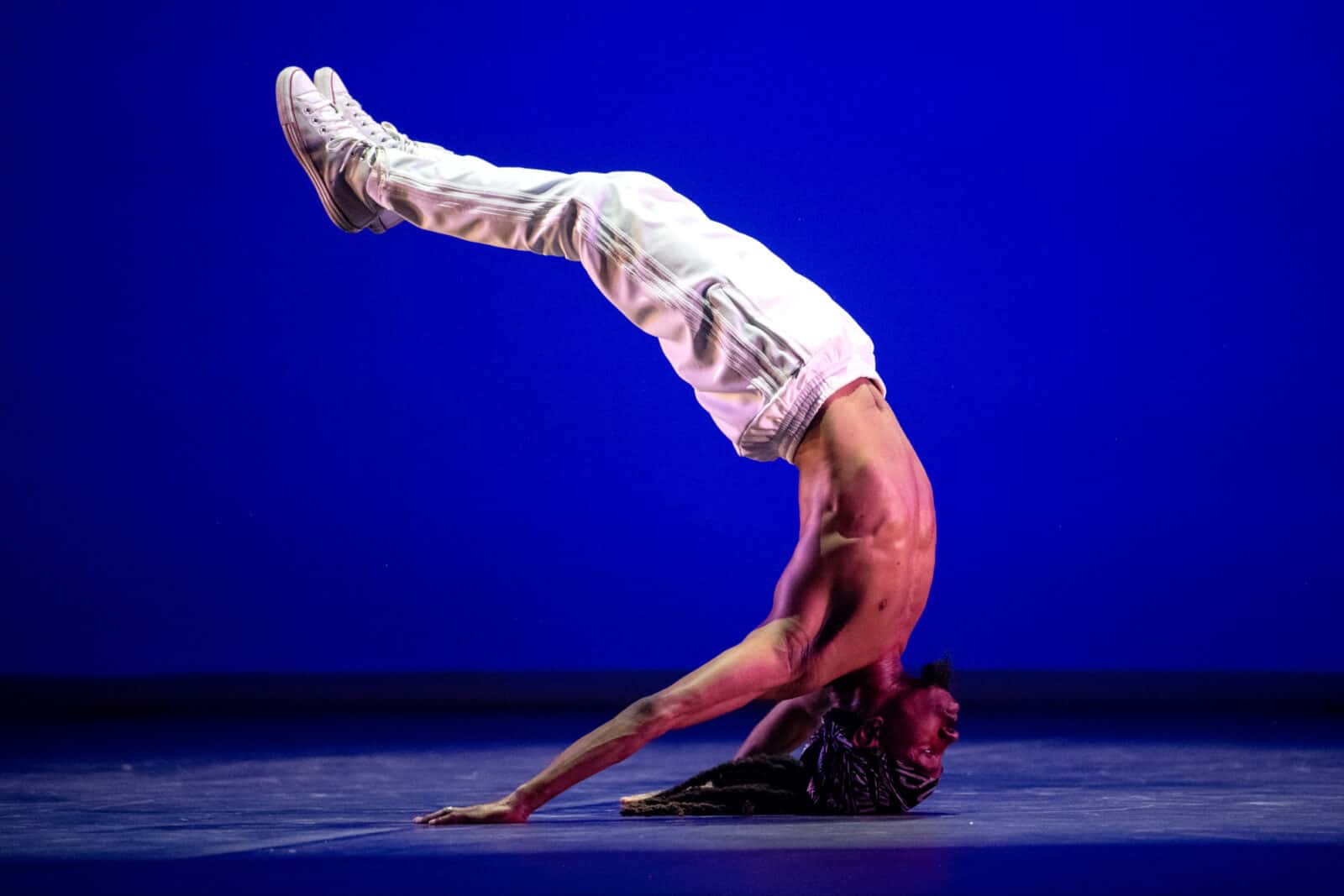 Joshua Culbreath arcs upside down in 'Nuttin' but a Word' with Rennie Harris Puremovement American Street Dance Theater. Press photo courtesy of Jacob's Pillow