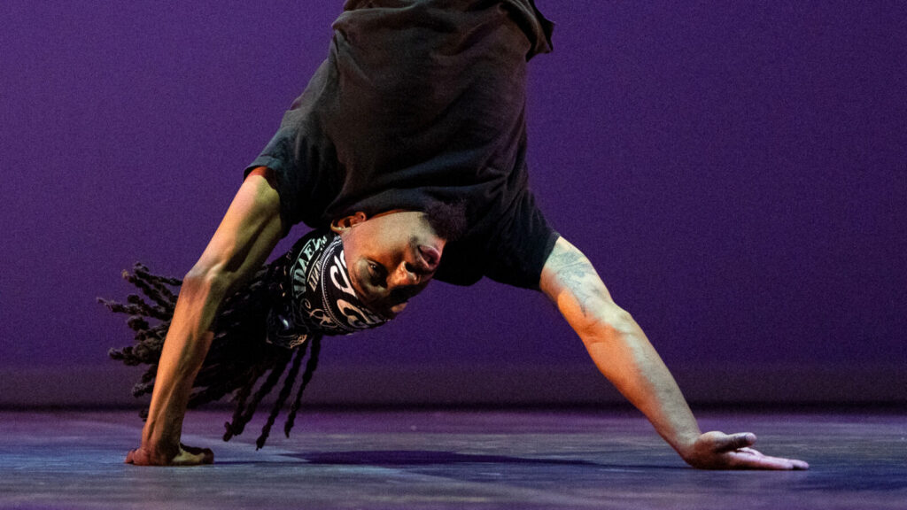 Joshua Culbreath stands on his hands in 'Nuttin' but a Word,' as Rennie Harris' Puremovement American Street Dance Theater celebrate 50 years of Hip Hop. Press photo courtesy of Jacob's Pillow