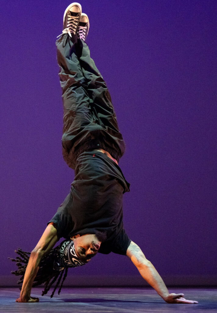 Joshua Culbreath stands on his hands in 'Nuttin' but a Word,' as Rennie Harris' Puremovement American Street Dance Theater celebrate 50 years of Hip Hop. Press photo courtesy of Jacob's Pillow