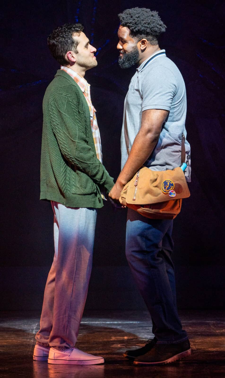 Adam Chanler-Berat and Darrell Purcell, Jr, hold hands smiling in A New Brain. Press photo courtesy of Barrington Stage Company