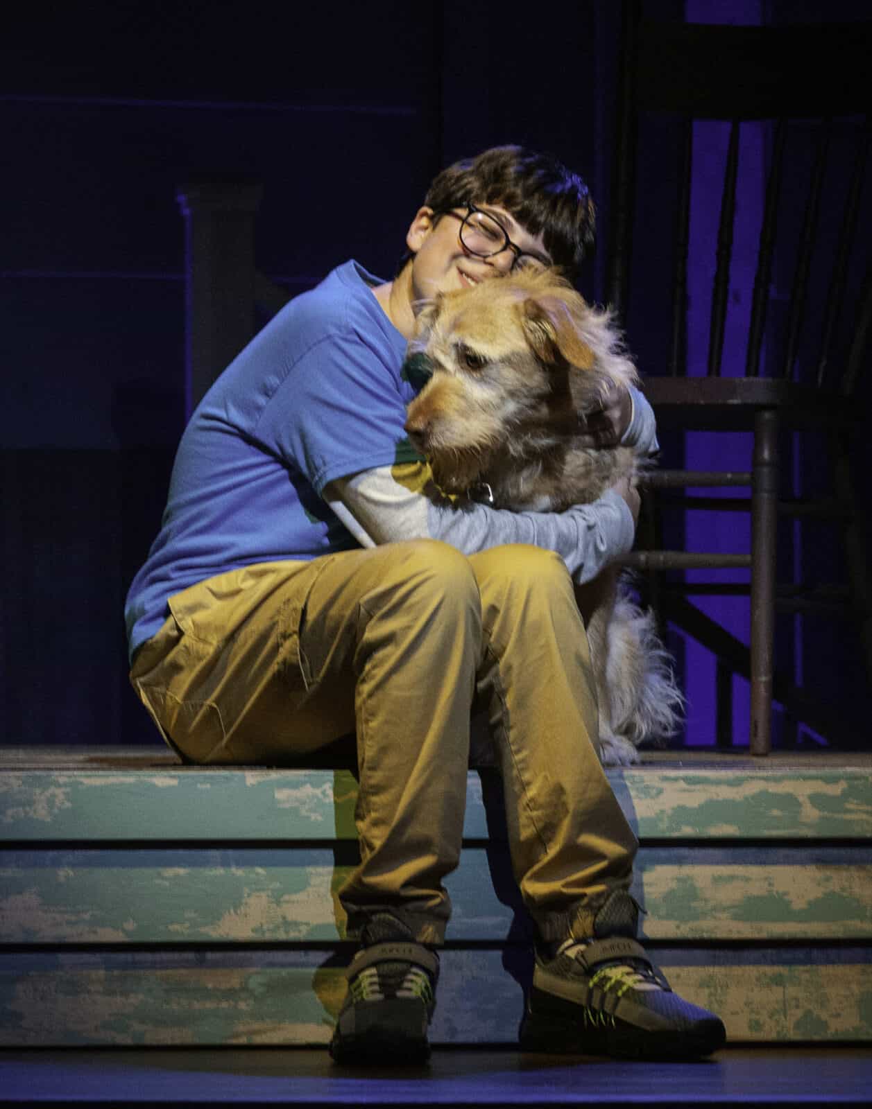Hayden Hoffman as Jamie hugs Charlie the dog in On Cedar Street. Press Photo courtesy of Berkshire Theatre Group